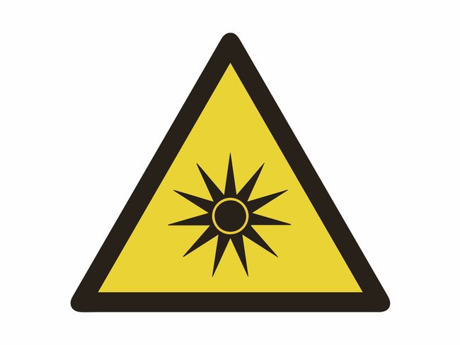 Un triangolo giallo con bordo nero contenente all'interno una figura nera a forma di tabella. Questo è il simbolo di avvertimento della presenza di raggi UV.
