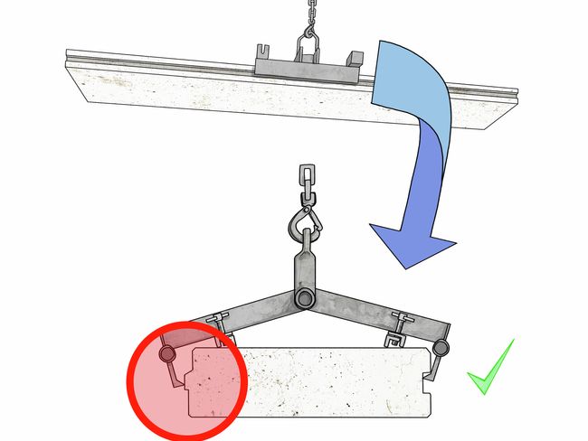 Plaque de béton suspendue de travers dans un dispositif de préhension. Une vue détaillée montre que, d’un côté, le grappin n’atteignait pas le dessous de la crête.