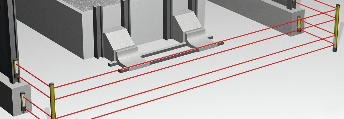 Eine Lichtschranke mit vier Lichtstrahlen ist vor einer Anlage am Boden positioniert. 
